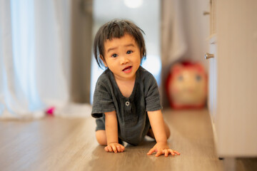Curious Toddler Touching Air Purifier Indoors.