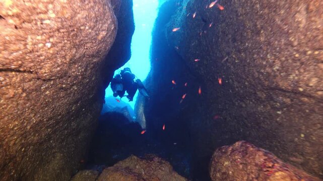 Scuba  diver coming out of a cave