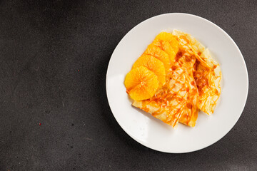 Crepes with oranges sweet dessert pancakes tasty snack fresh delicious gourmet food background on the table rustic food top view copy space