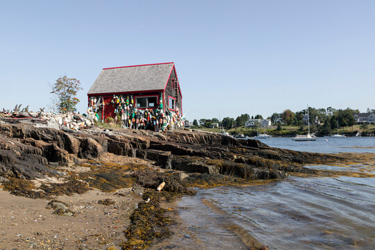Wooden Shed Exterior Covered with Hanging Marker Buoys