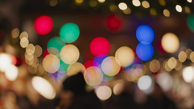 Abstract motion background of giant colorful out of focus bokeh lights pulsating gently like a dreamy festive holiday market atmosphere shallow depth, texture, looping