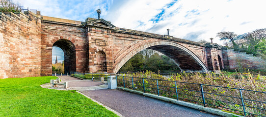 A panorama view along the banks of the River Dee past the Grosvenor Bridge in the city of Chester, Cheshire, UK