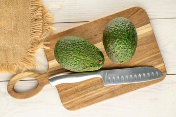 Ripe avocados on a wooden table, close-up, top view.