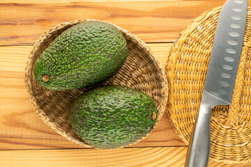 Ripe avocados on a wooden table, close-up, top view.