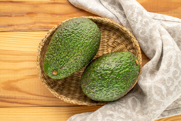 Ripe avocados on a wooden table, close-up, top view.