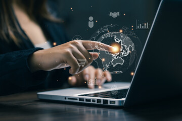 A professional interacting with a digital globe interface above a laptop, representing global business, online commerce, international connectivity, digital economy, and worldwide market expansion.