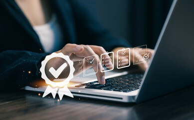 A professional working on a laptop with digital approval and checklist icons, representing quality assurance, business verification, compliance process, and professional workflow management.