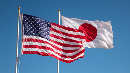 us flag waving next to japanese flag in blue sky. relations between usa and japan