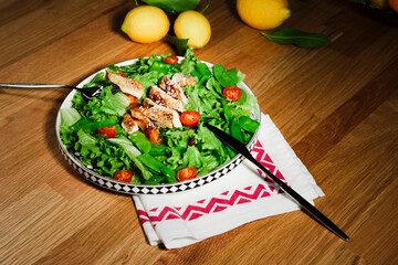 grilled chicken salad with green lettuce, grilled meat, green peas, tomatoes, lemons, fresh natural healthy mediterranean styled meal