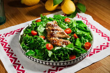 healthy chicken salad with lettuce, green peas, cherry tomatoes, olive oil dressing, close up