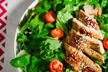 healthy chicken salad with lettuce, green peas, cherry tomatoes, olive oil dressing
