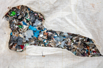 shredded and pressed recyclable plastic waste that has been burned and causes environmental pollution.