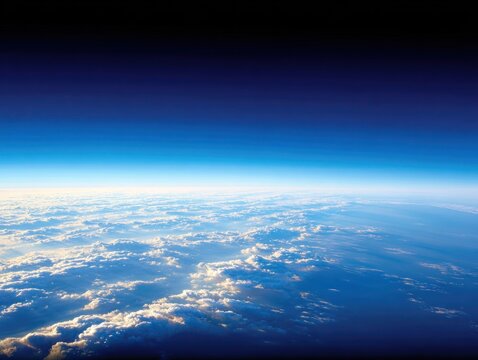 View of clouds and sky from high altitude with horizon line visible above earths surface