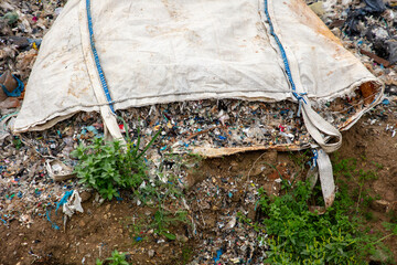 shredded and pressed recyclable plastic waste that has been burned and causes environmental pollution.