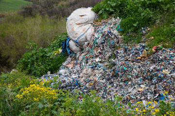 shredded and pressed recyclable plastic waste that has been burned and causes environmental pollution.
