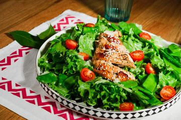 grilled chicken salad with green lettuce, grilled meat, green peas, tomatoes, lemons, fresh natural healthy mediterranean styled meal