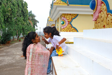 Family time on steps in a colorful temple courtyard