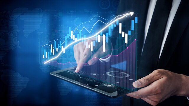A professional man interacts with a tablet displaying financial graphs and data indicators, illustrating trends and opportunities in a digital workspace environment. Copula - Powered by Adobe