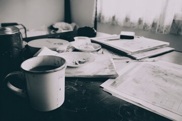 Cozy workspace with coffee cup, documents, and notepad, perfect setting for productivity and inspiration in home office.