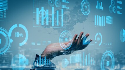 A futuristic hand illustrates various charts and graphs over a city skyline, symbolizing the integration of data analytics and technology in business strategies. Xenic