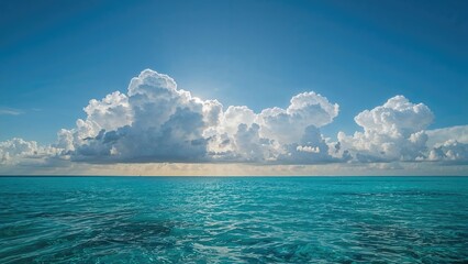 A vast ocean under a sky filled with large, fluffy clouds during daytime.