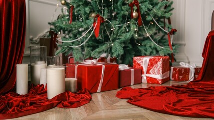 Festive Christmas tree with red gifts and candles creating a cozy holiday atmosphere