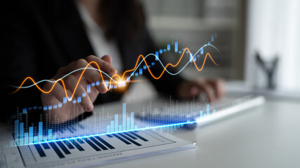 A professional examines market trends with hands-on analysis, using digital graphs and charts to drive informed decision-making in a modern business environment. Scalp