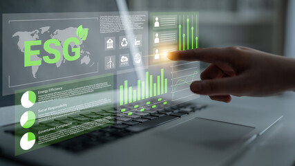 A hand interacts with a digital ESG interface on a laptop, illustrating essential metrics and charts for sustainability and governance in modern business practices. Gantry