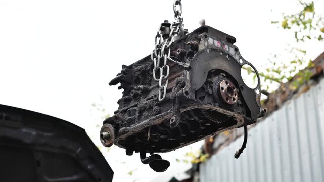 Old dirty car engine block lifting for repair