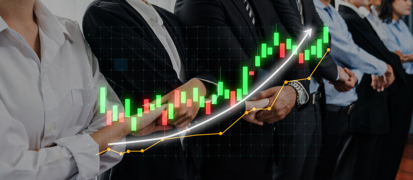 A group of diverse business professionals stands together in formal attire, with a financial growth chart overlay symbolizing economic progress and investment success. Axiom - Powered by Adobe