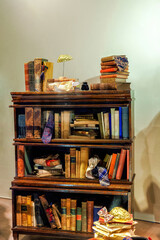 Antique low wooden bookcase filled with row old books, sophisticated and intellectual atmosphere