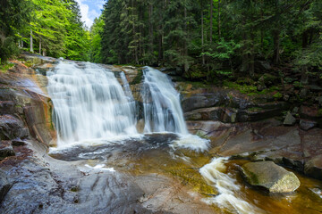 Mumlavsky waterfall flowing over granite rocks in Harrachov