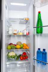 Refrigerator filled with fresh healthy food and drinks