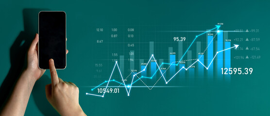 A businessman interacts with a smartphone displaying financial data and trends, representing modern analytics and investment strategies in a digital landscape. Scalp