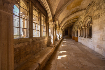 Vezelay basilica cloister hall with sun illuminating columns
