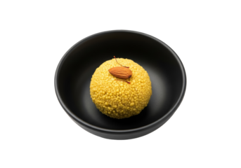 besan laddu yellow sweet in black bowl with almond garnish