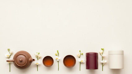 Horizontal tea border featuring Qingming festival background with orchids and wooden caddy, minimalist spring design with copy space