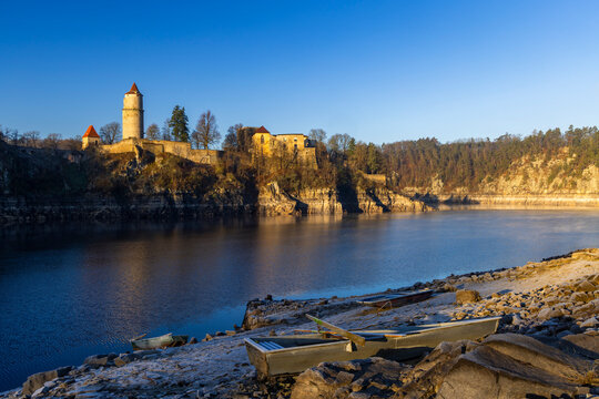Zvikov Castle towering above Vltava river with boats