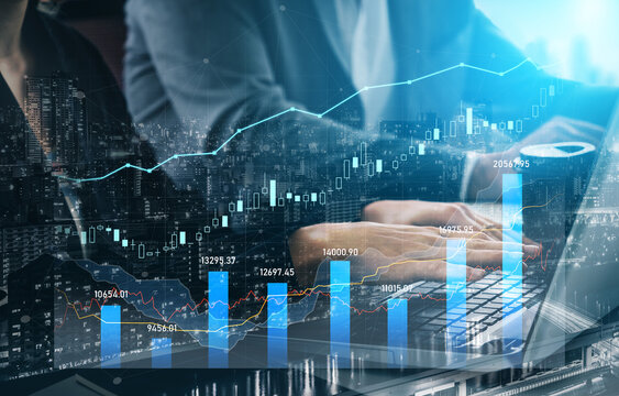 A business professional examines stock market trends through digital graphs on a laptop, situated in a modern office, surrounded by a city skyline at night. Scalp - Powered by Adobe