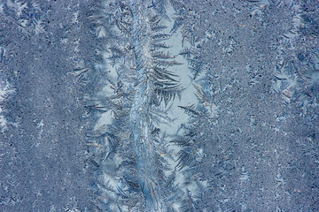 Ice crystals in the detail on a window glass in winter time