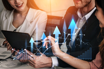 A business team collaborates in a modern office setting, analyzing data trends on a tablet to make informed decisions and drive financial growth effectively. Scalp