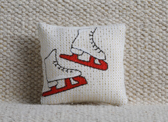 Cushion with skates on sofa