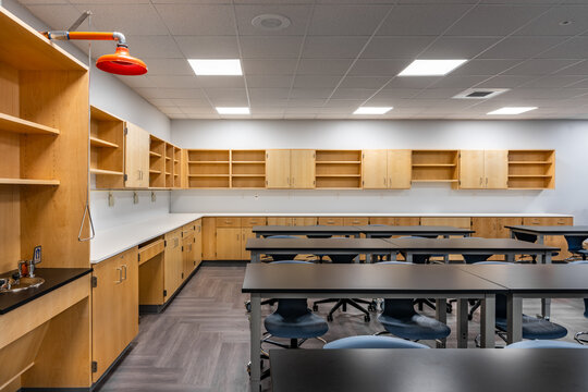 Example of a new empty nondescript US High School science classroom with desks, chairs, and white board. Classroom could be in almost any US High School. Nobody included in image.