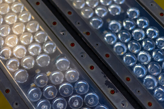 Close-up of industrial led light panels with circular lenses in metal casings