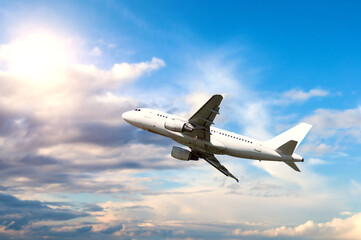 Obraz premium Airplane flying in the vast blue sky, air travel background, concept of summer vacation and business trip