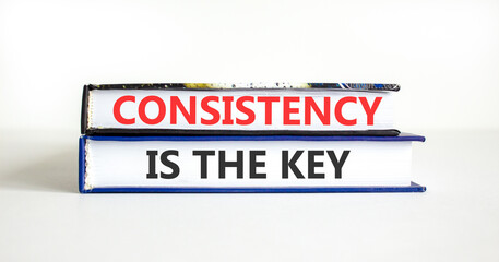 Fototapeta premium Consistency is the key symbol. Concept words Consistency is the key on beautiful books. Beautiful white paper background. Business consistency is the key concept. Copy space.