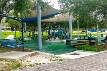 Outdoor children&rsquo;s play area with bright slides near brick apartment building