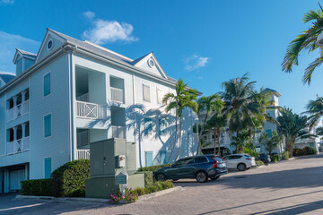 Tropical wooden house with white fence and palm trees in Key West, Florida