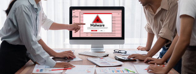 Cyber attacking concept. Malware alert showing on computer screen display scam and threat detection on computer system or online server to be removed brisk.