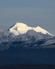 Sun illuminates the volcanic peak of Mount Baker in the North Cascades